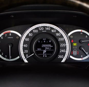 Car speedometer with kilometer per hour and tachometer,fuel meter,odometer and warning light on a car dashboard.